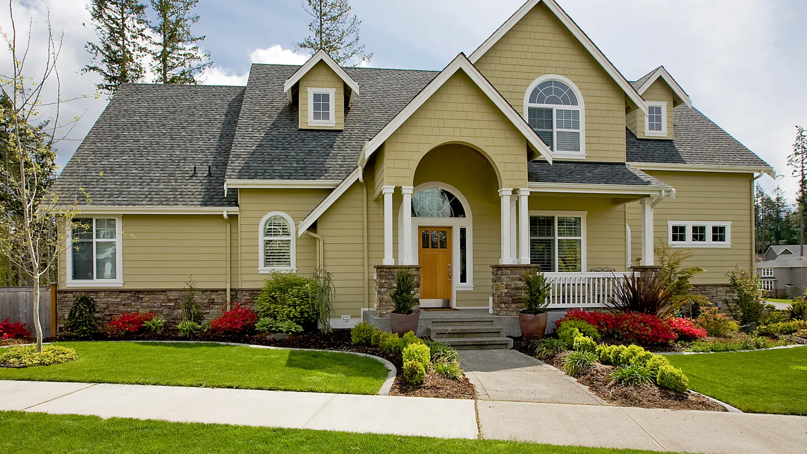 a house with a large front yard with Amelia Earhart Birthplace in the background