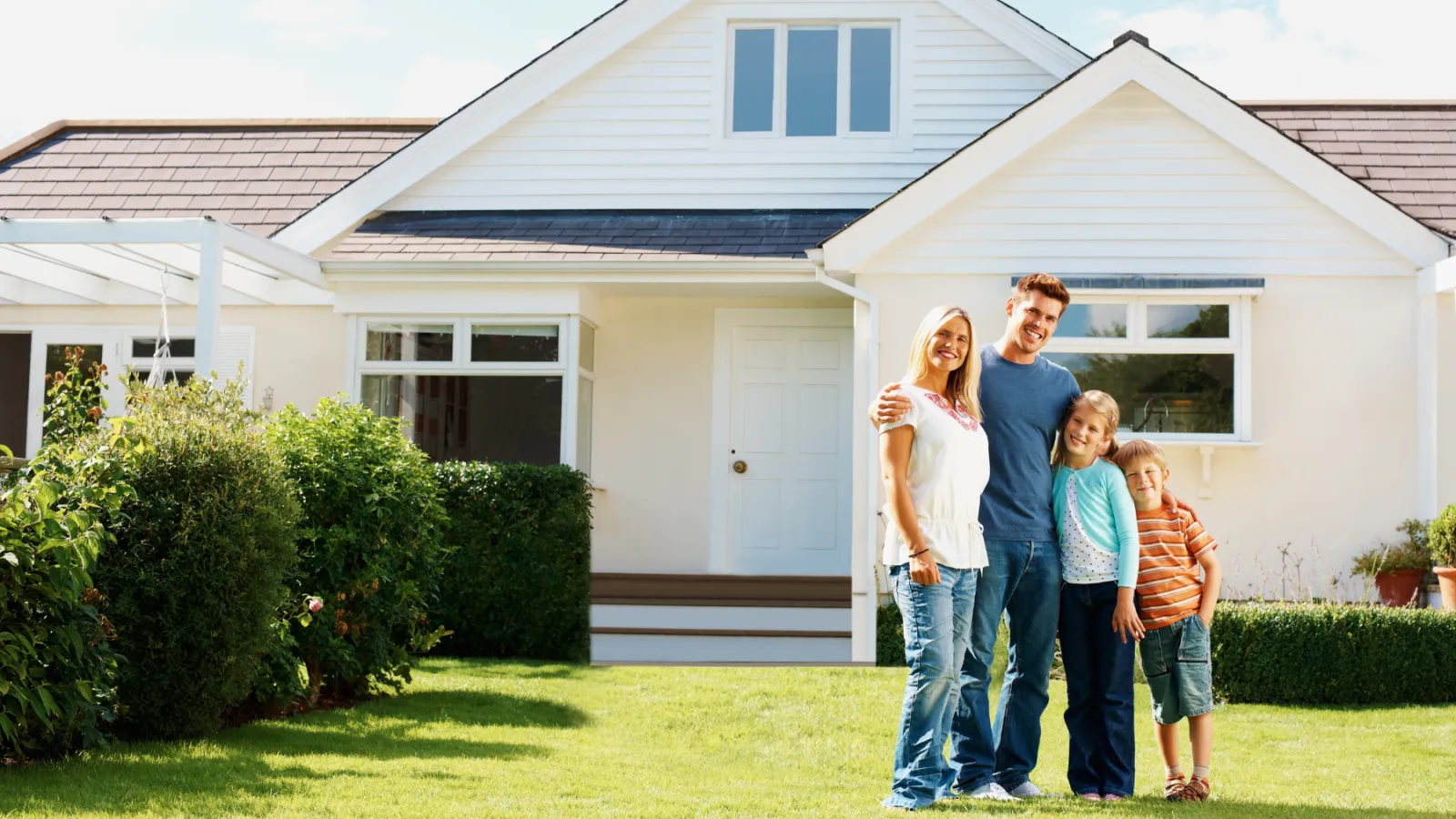 a family standing in front of a house