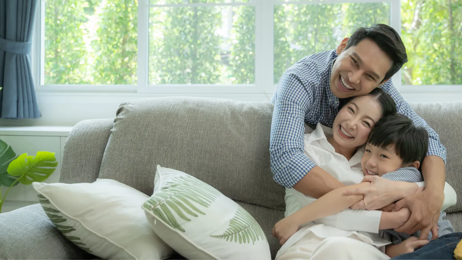 a man and woman with a couple of children on a couch