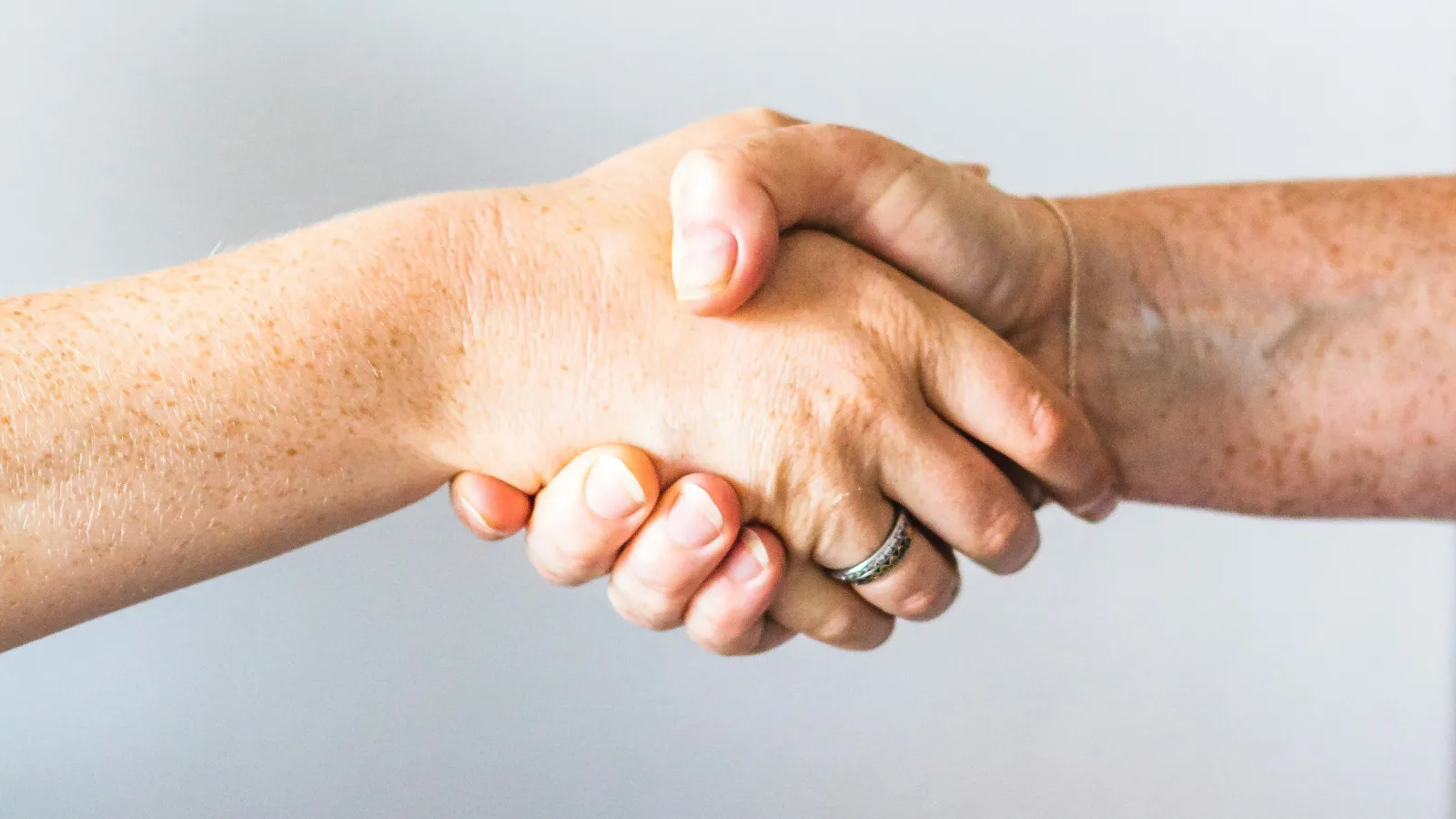 a close-up of hands shaking