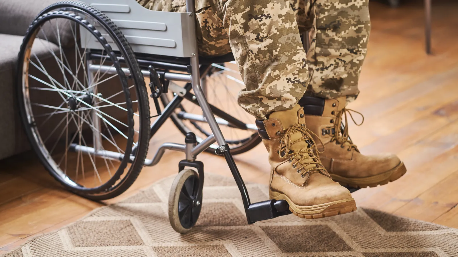 a person in military uniform sitting in a wheelchair