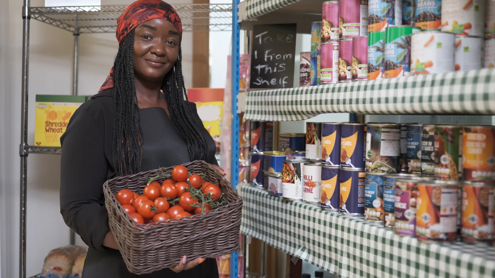 Mariam Olafuyi holding a basket of tomatoes