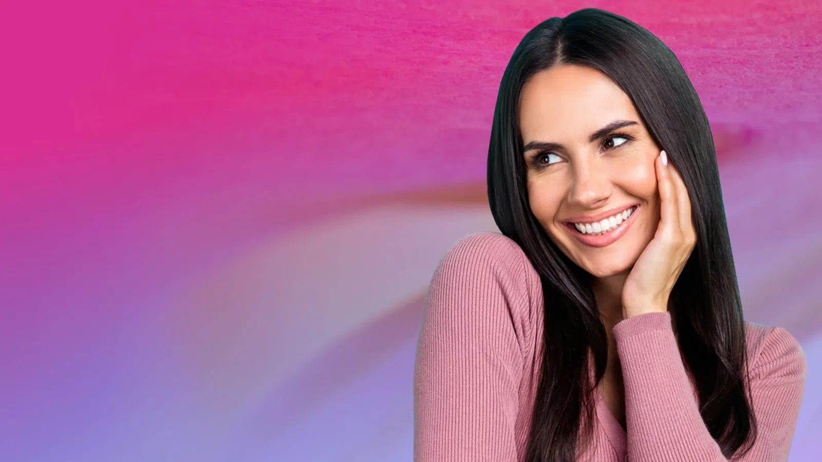 Smiling woman in pink sweater posing with hand on cheek against a vibrant pink and purple gradient background