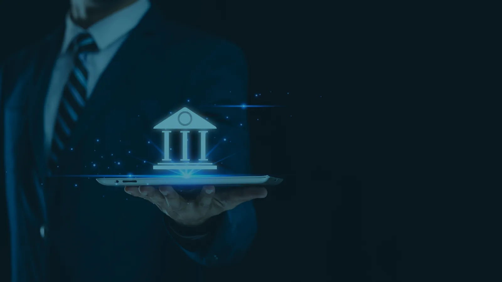 Businessman holding tablet with glowing digital bank building icon, symbolizing online banking and financial technology.