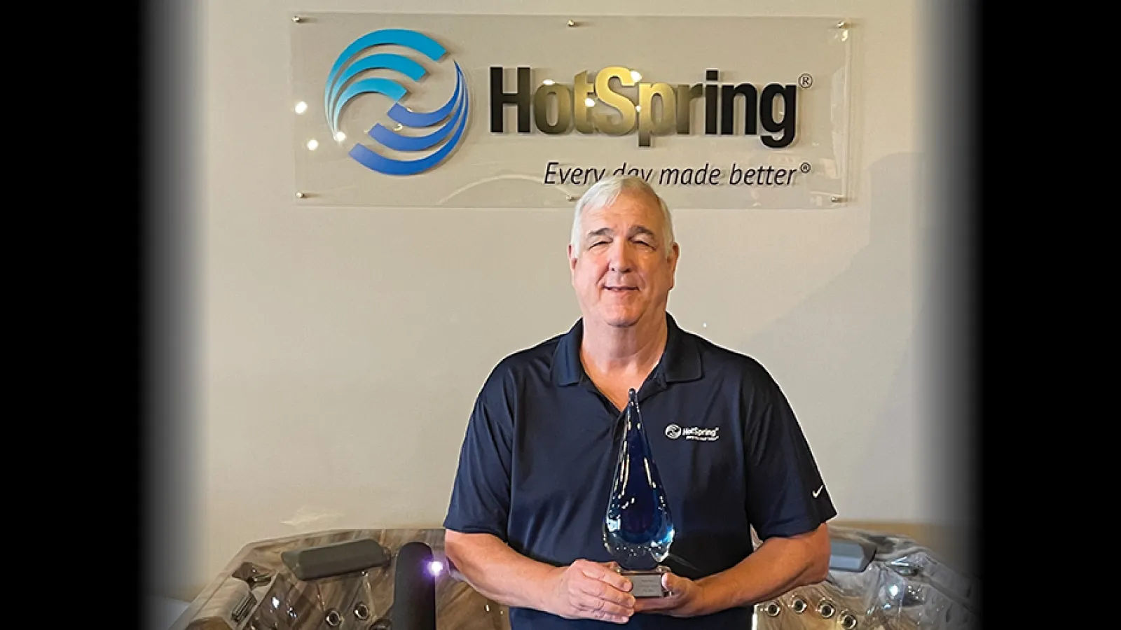 Mark Baker holds award