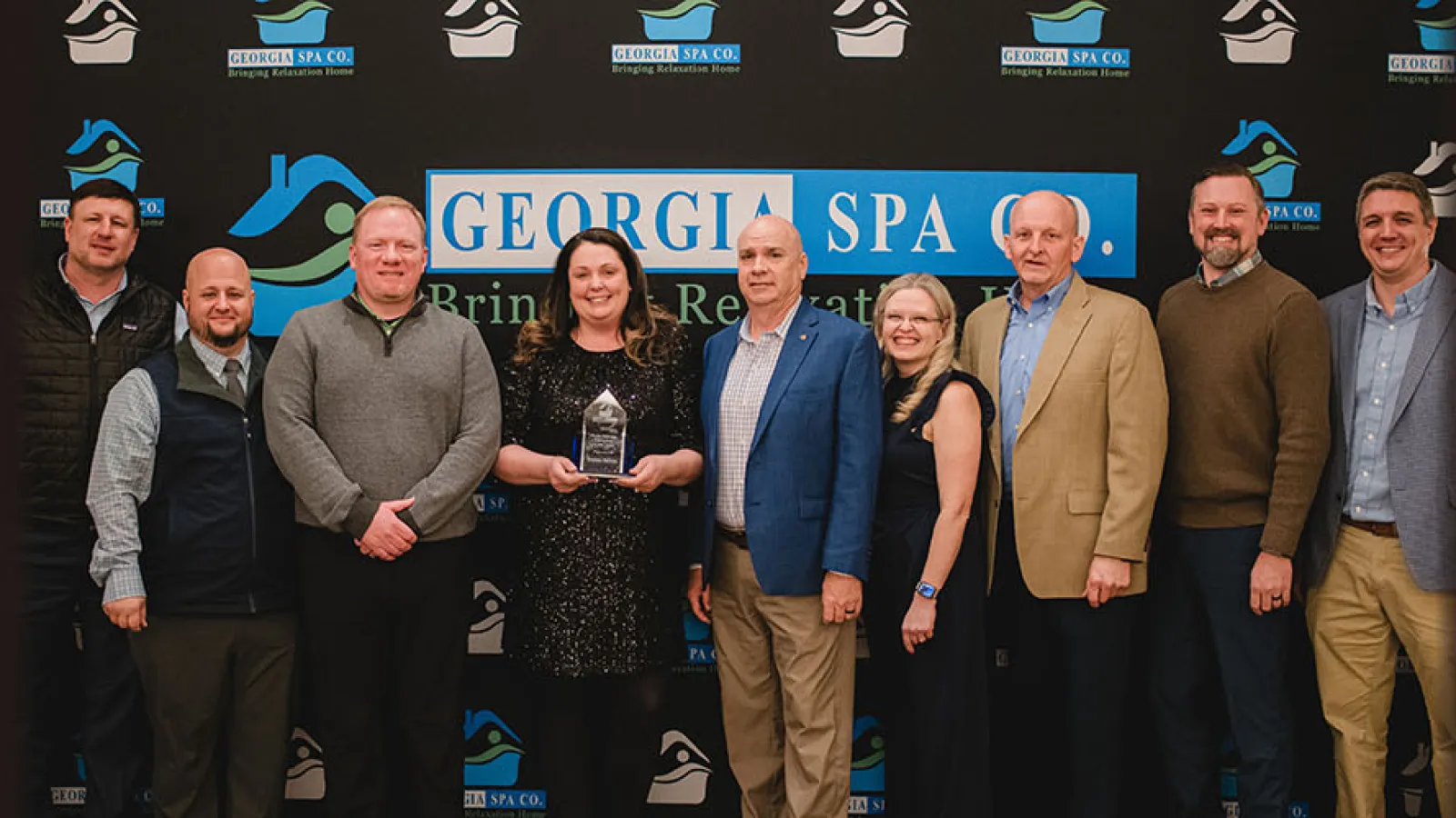Keisha Shiver accepts 2023 Employee of the Year Award with members of Georgia Spa's executive team.