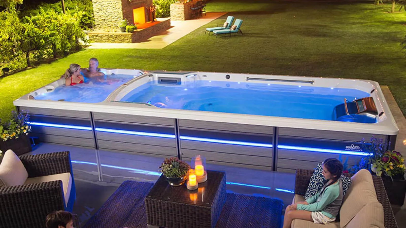 a swim spa with people sitting around it