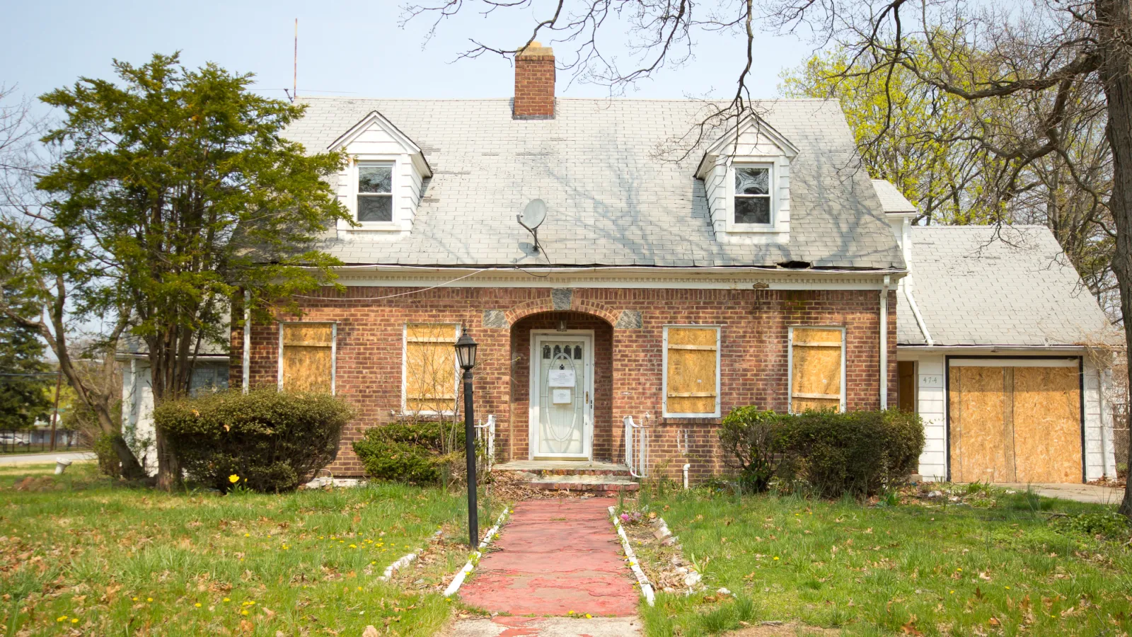 a brick house with a brick driveway