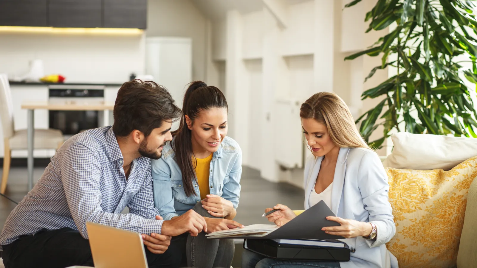 a group of people looking at a laptop