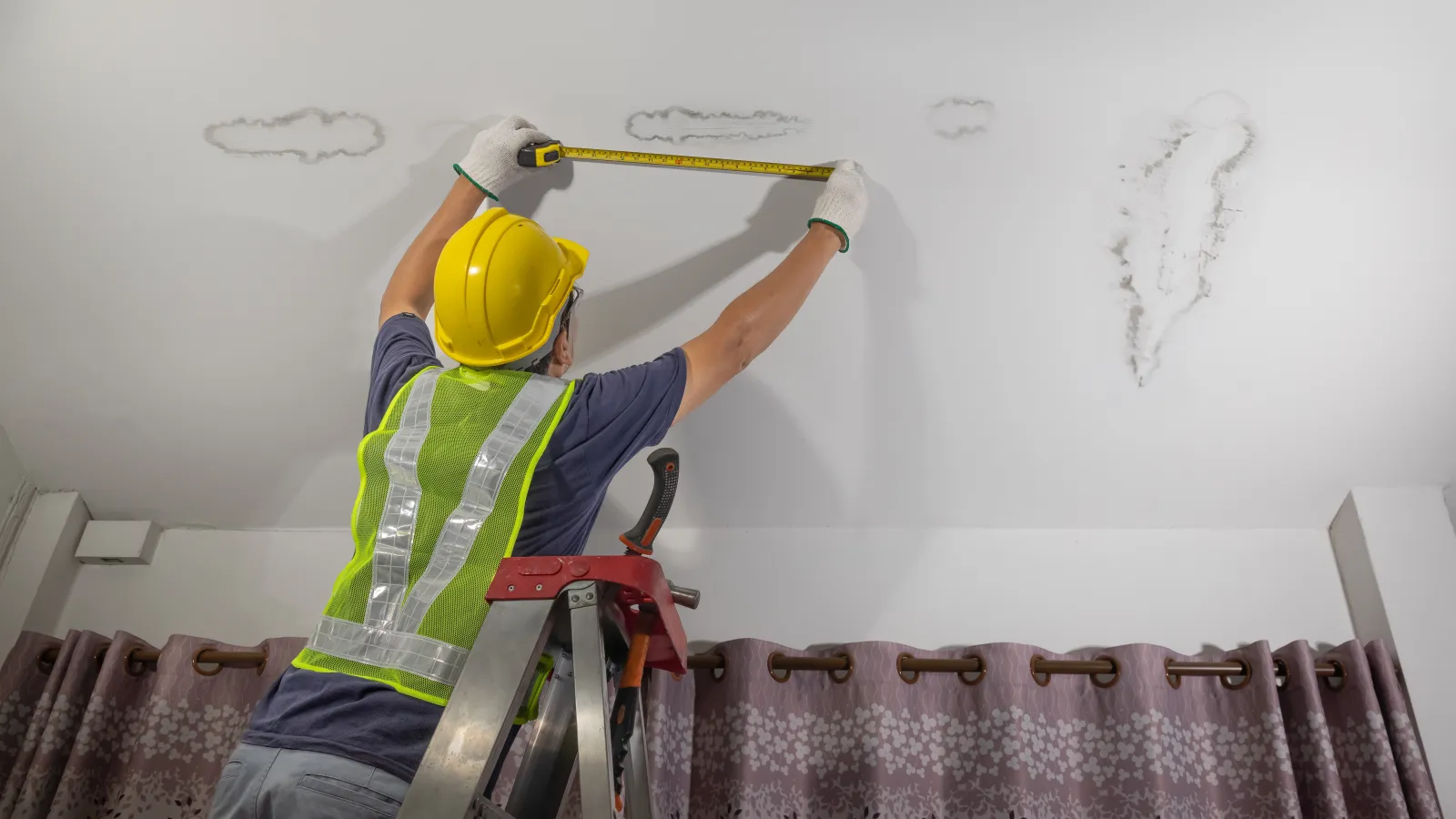 a person wearing a hard hat and holding a pipe
