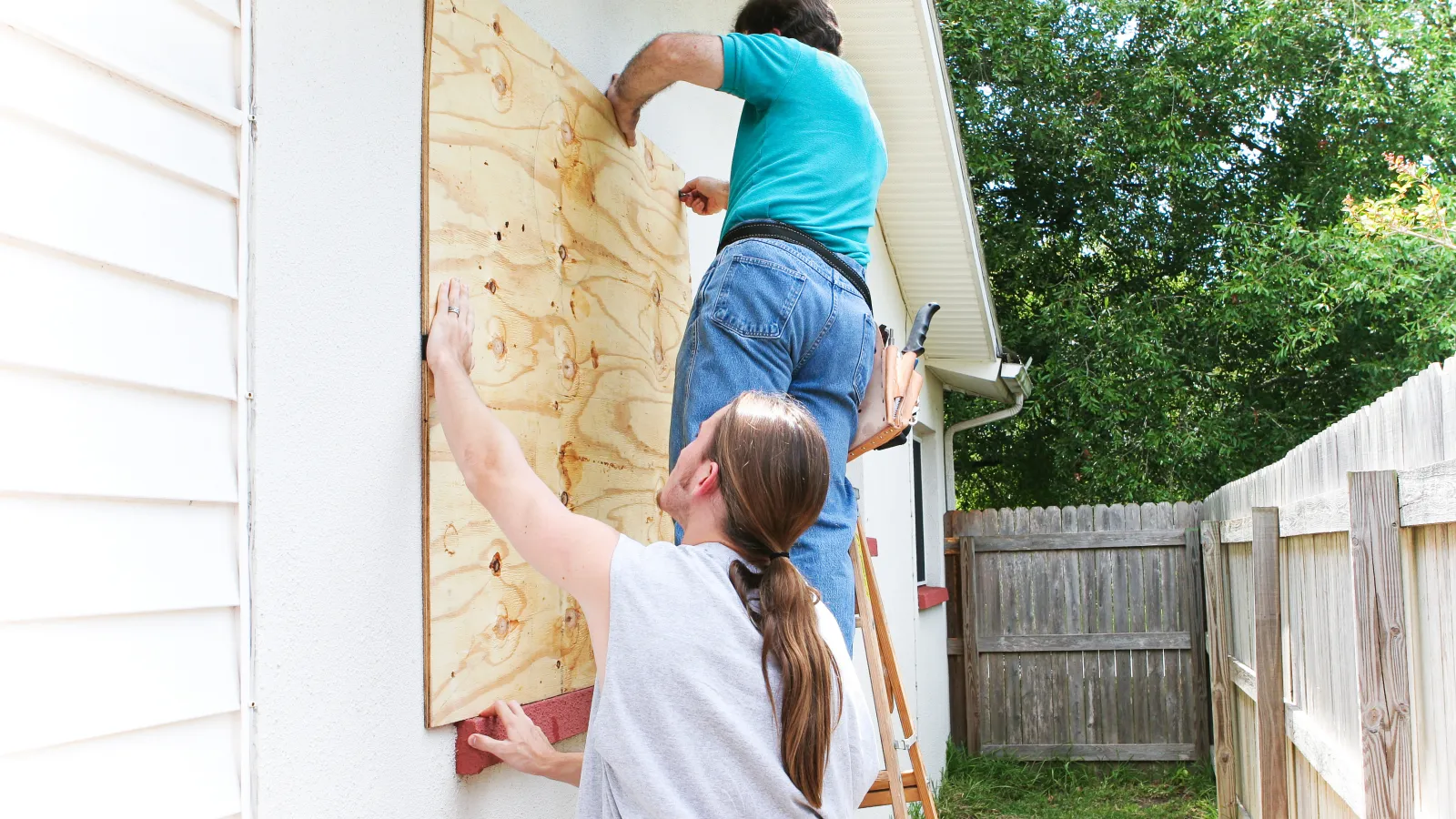 a person boarding up windows