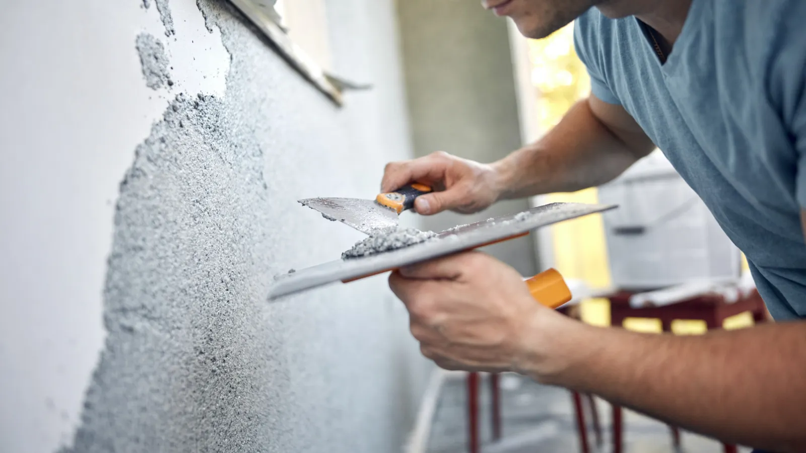 a man fixing a wall