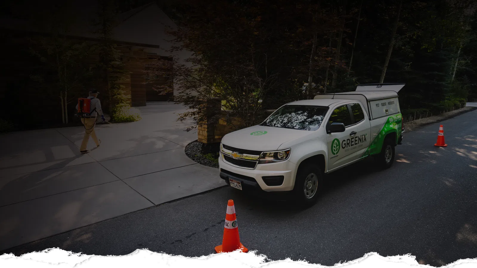 White Greenix service truck parked on a suburban street near orange cones and a worker walking toward a house.