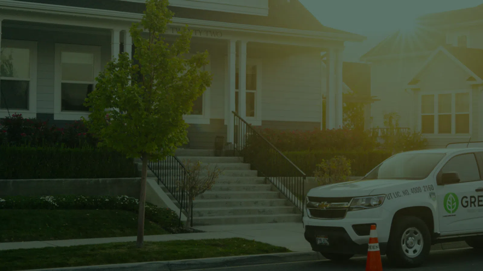a greenix truck parked in front of a house