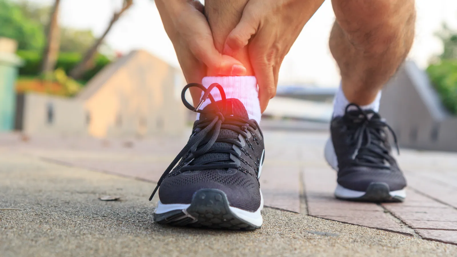 a close-up of a man holding his ankle
