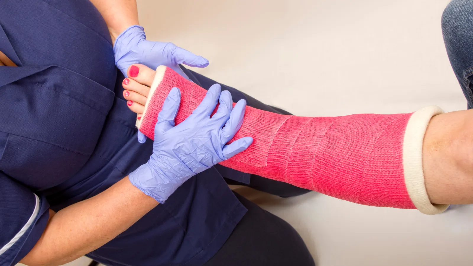 a person wearing a pink cast on their ankle