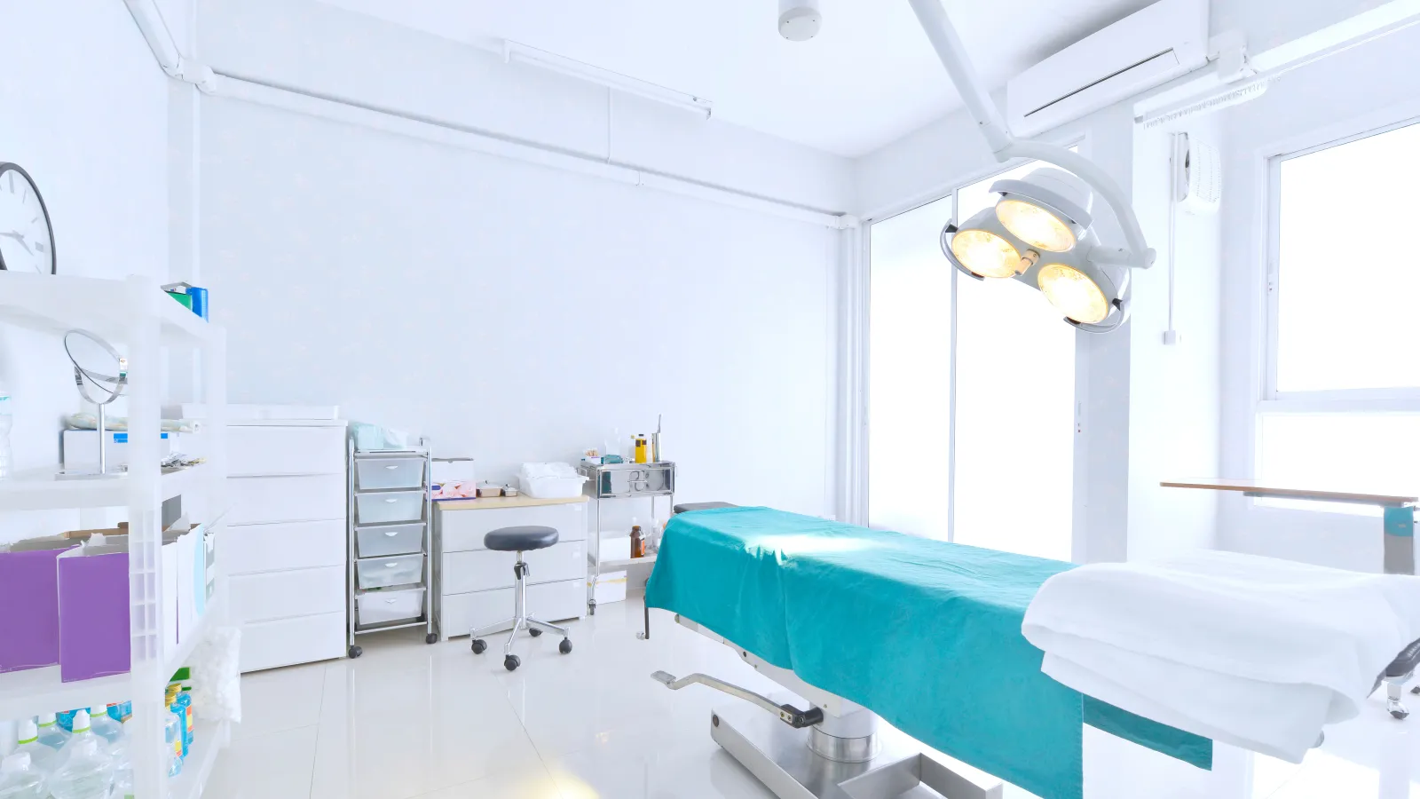 a hospital room with a bed and a desk