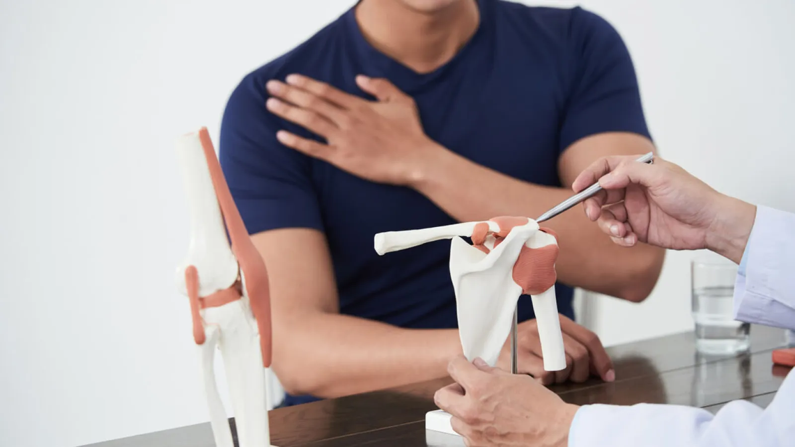 Doctor explaining to patient how a rotator cuff tear repair is performed