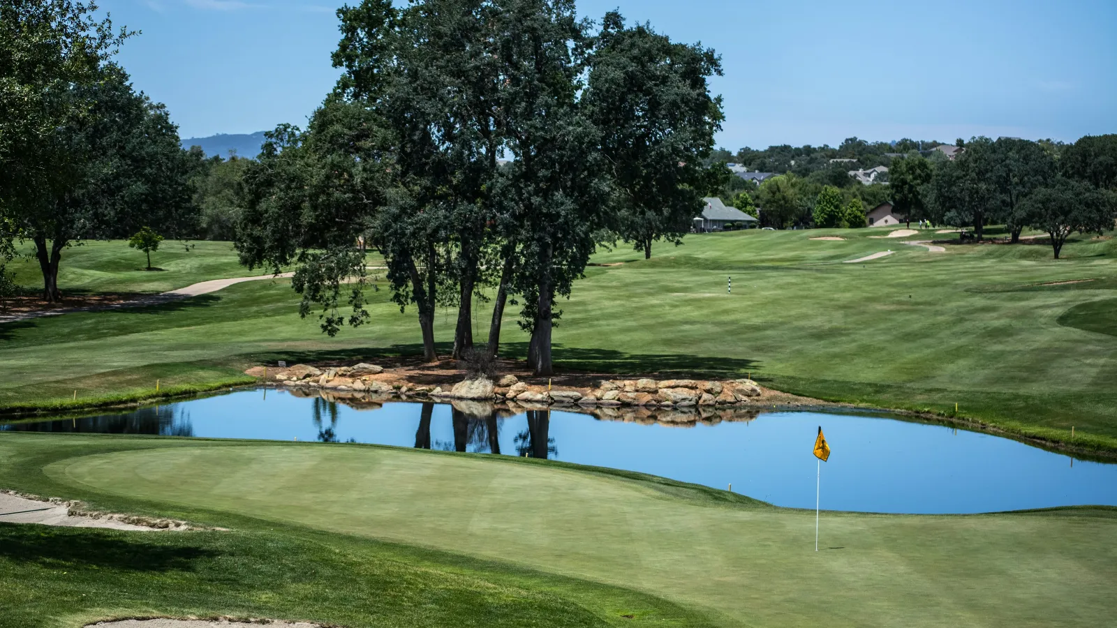 a golf course with a pond