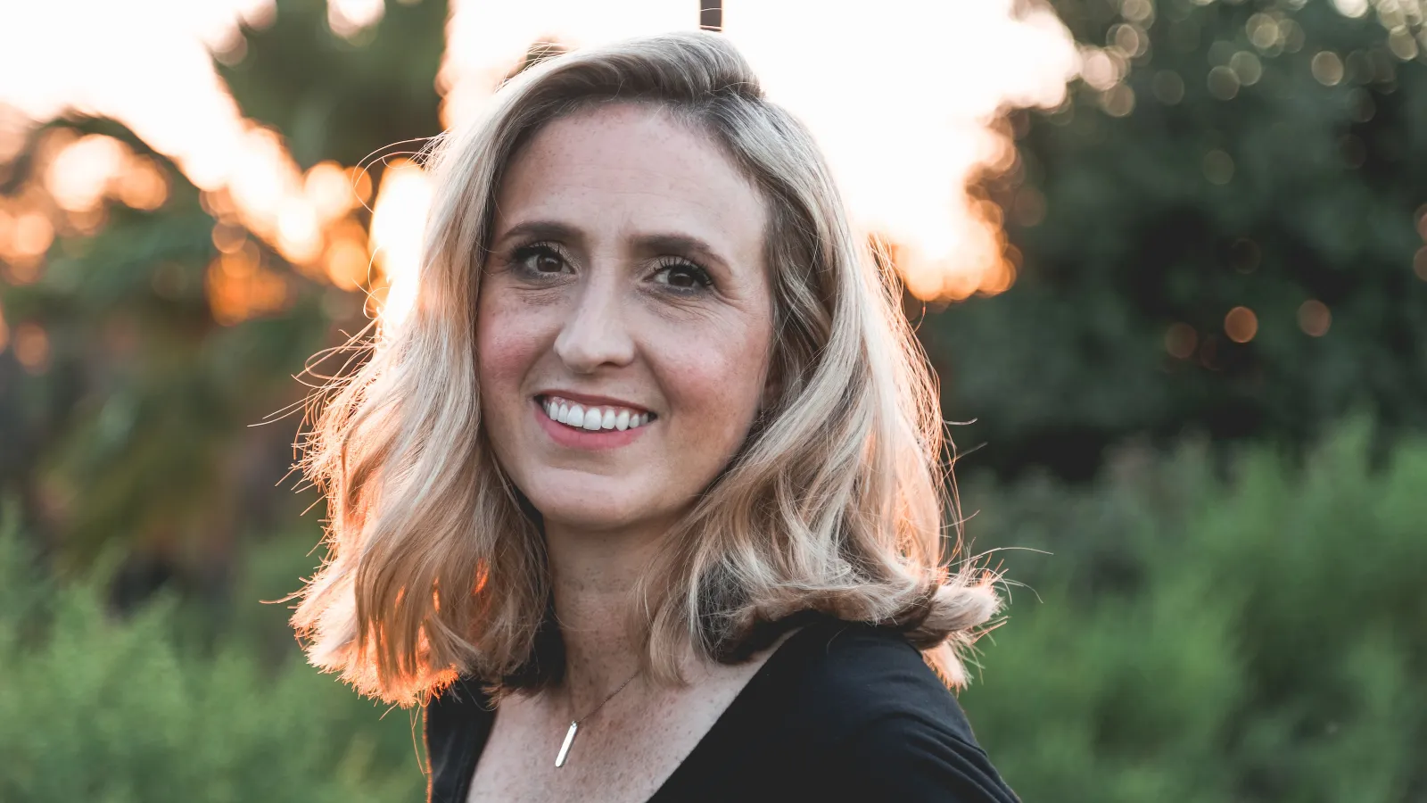 a woman smiling outside