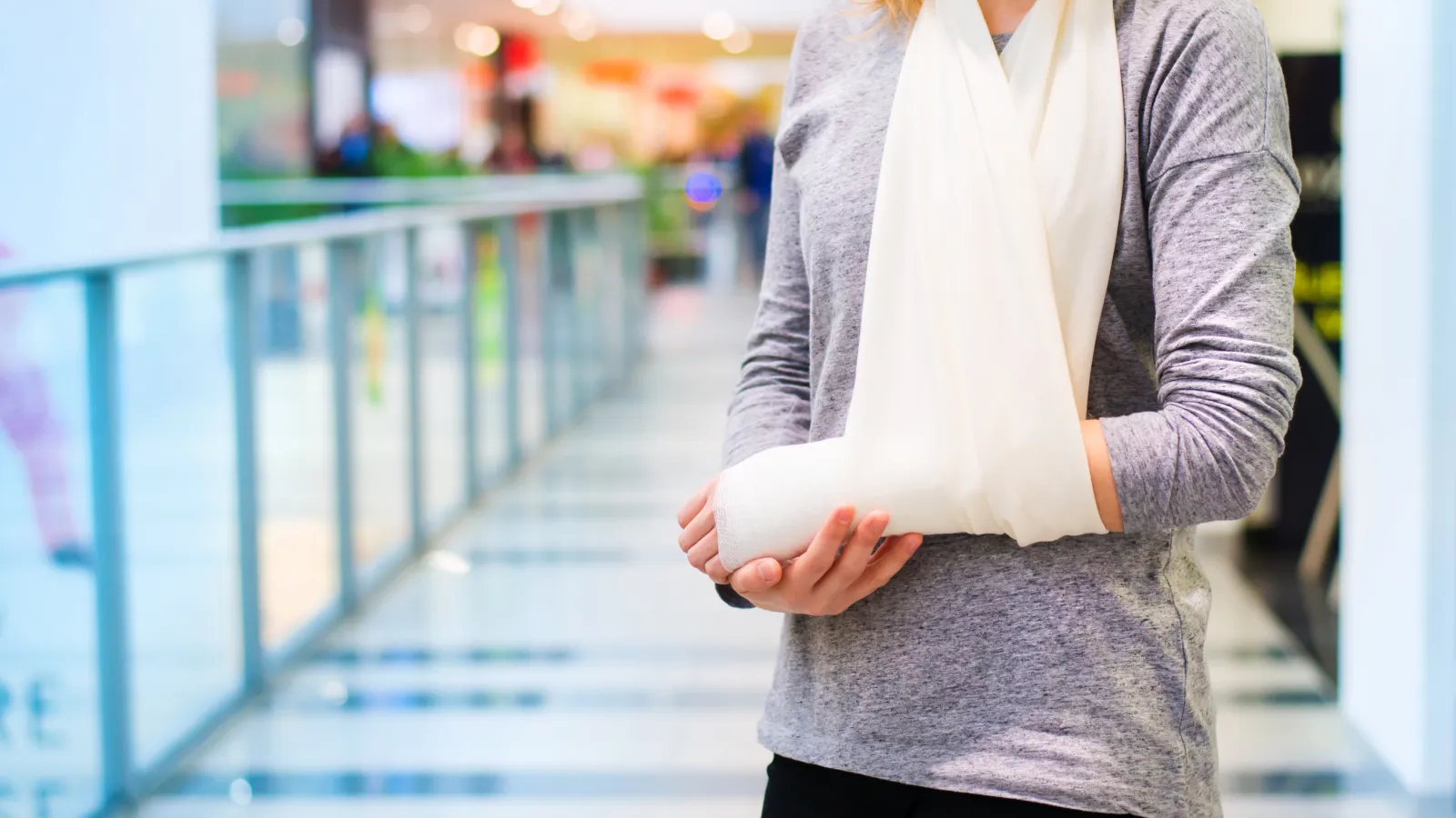 a person holding their broken arm