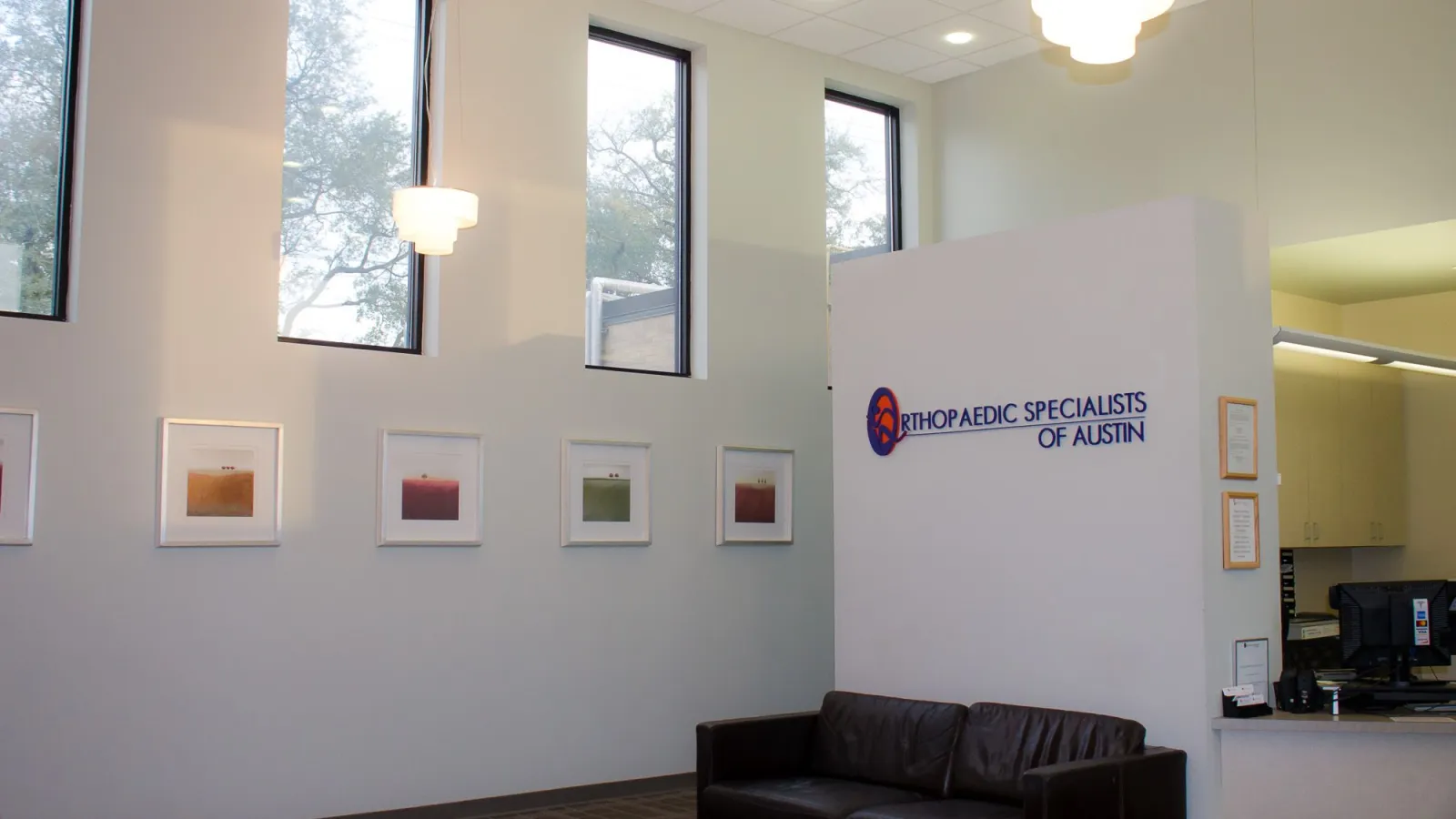 a room with a couch and a wall with pictures on it