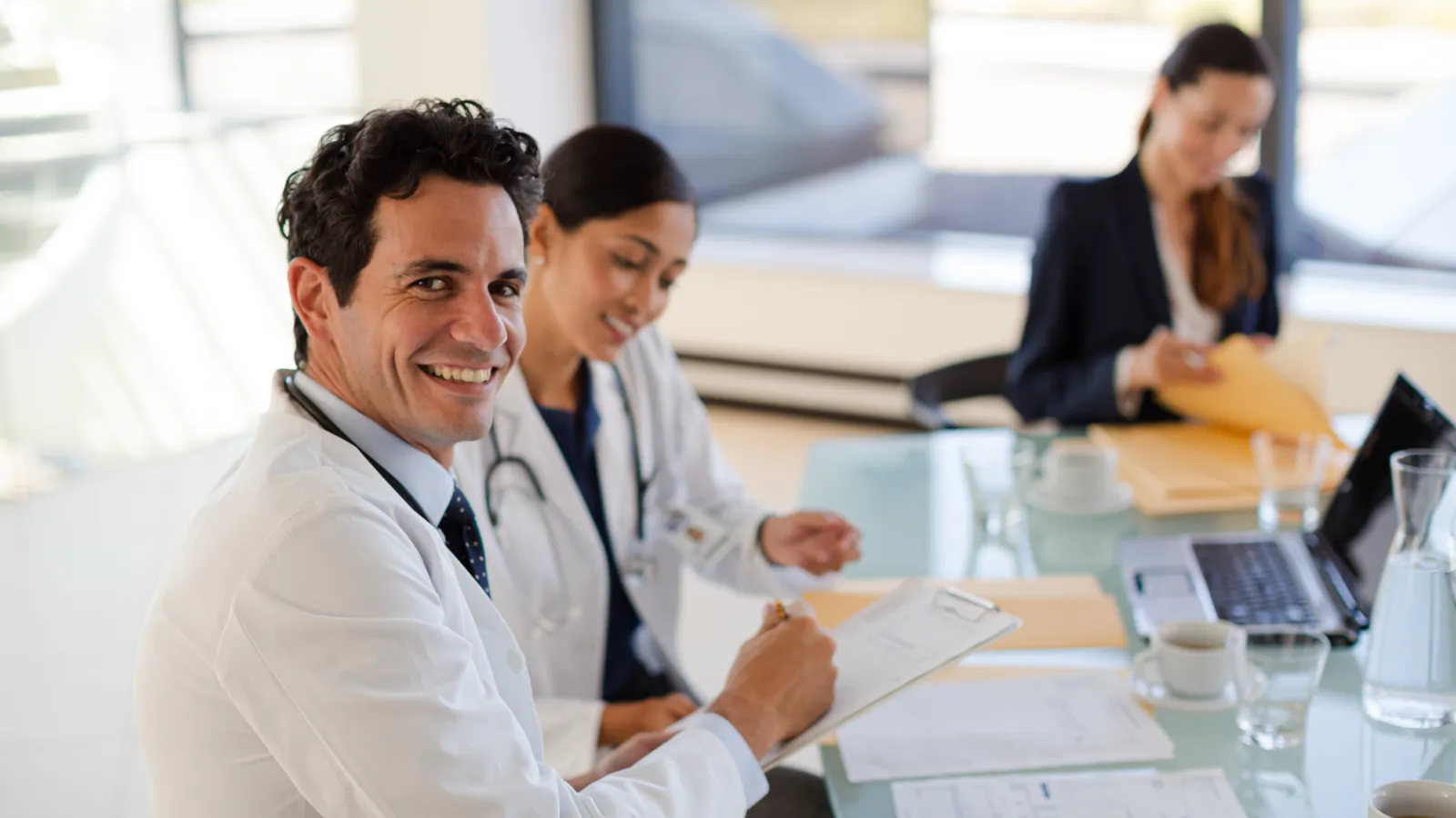a doctor sitting in a meeting
