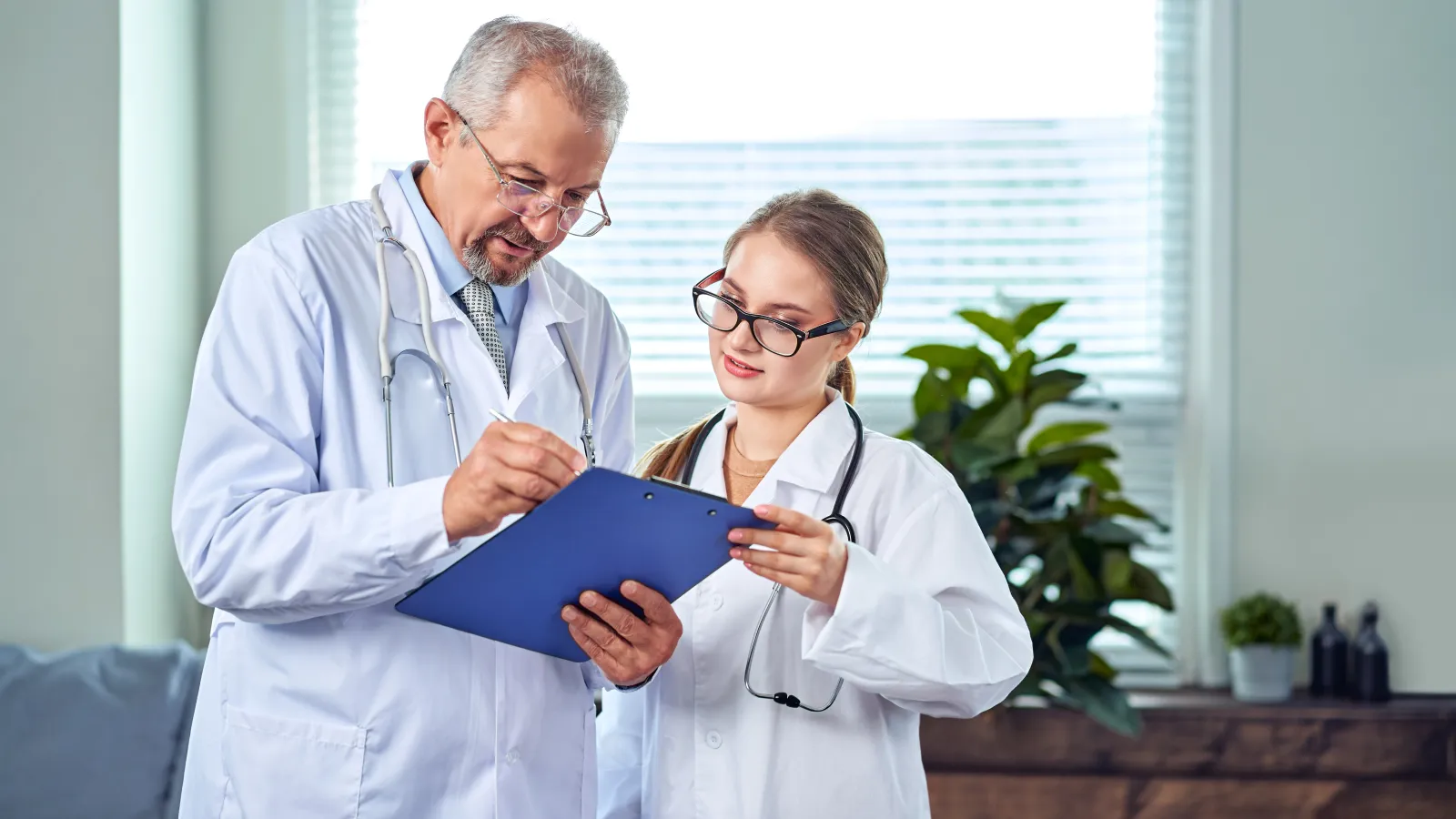 a doctor showing someone something on a clipboard