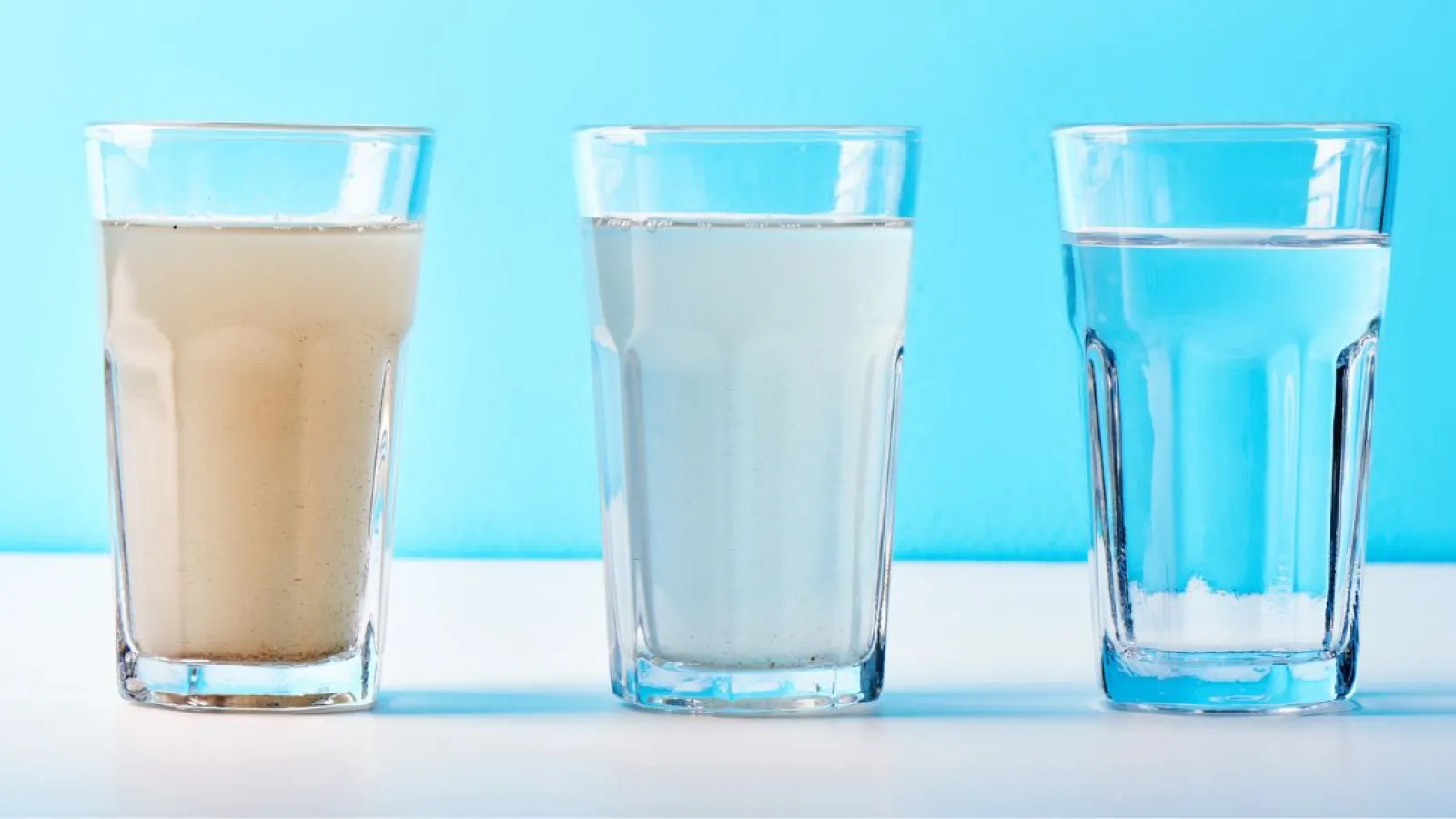 dirty and filtered water in a glass