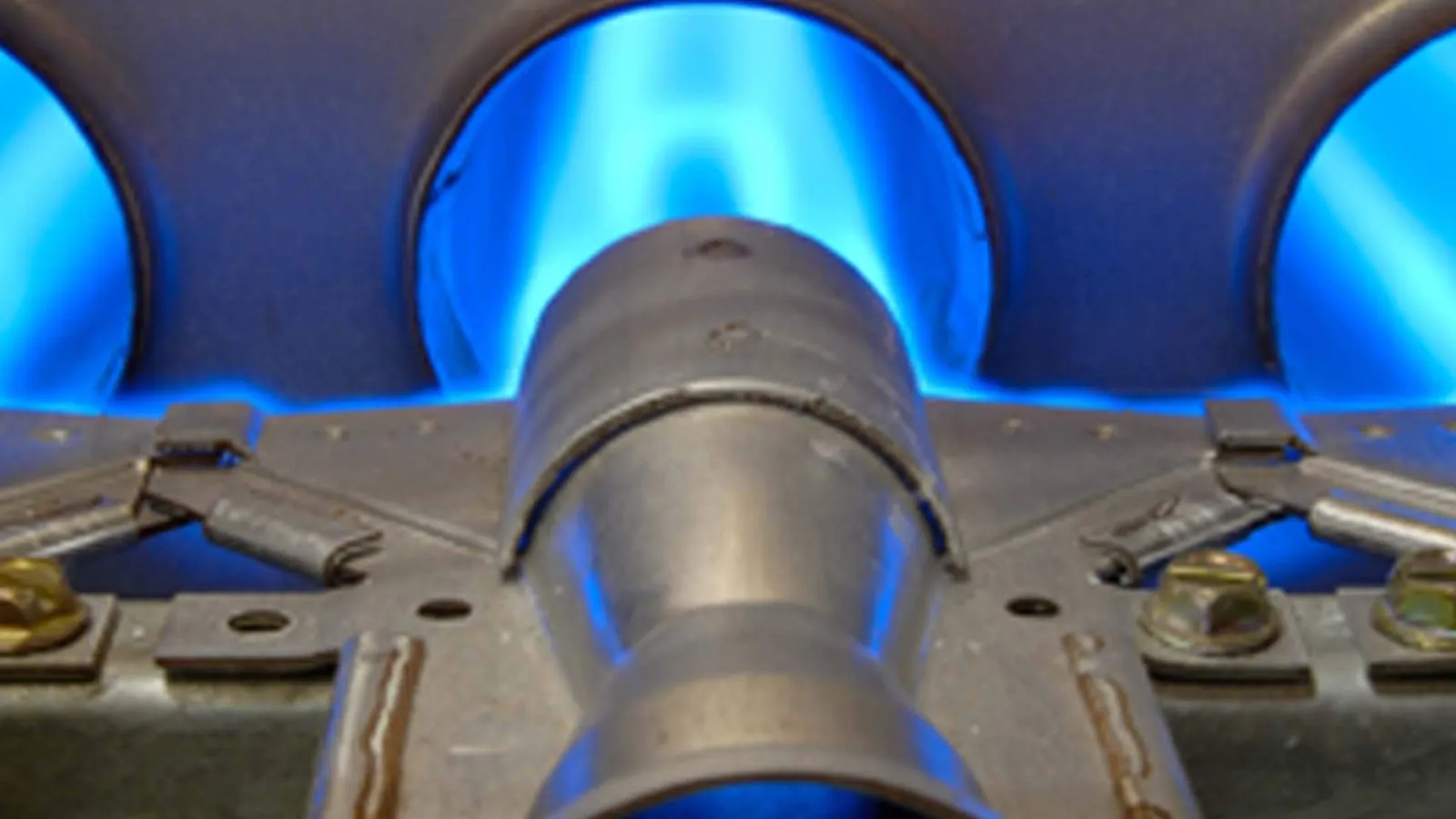 Close-up of blue gas flames burning inside a modern gas stove burner with metal components kennesaw ga