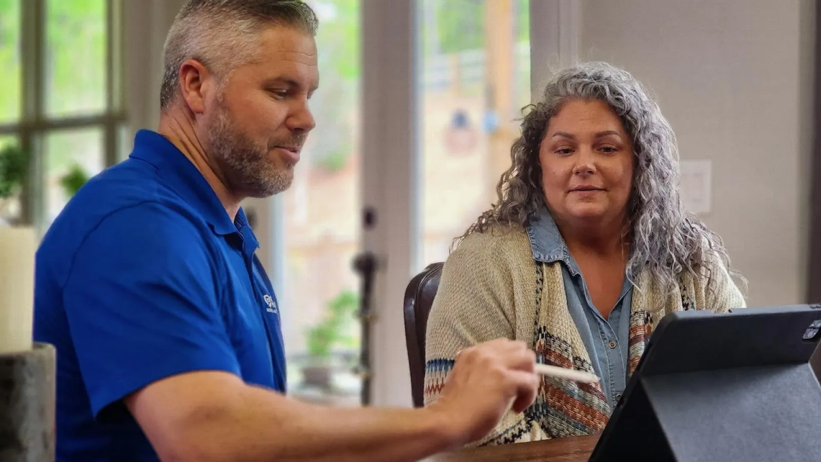 a man and a woman looking at a laptop