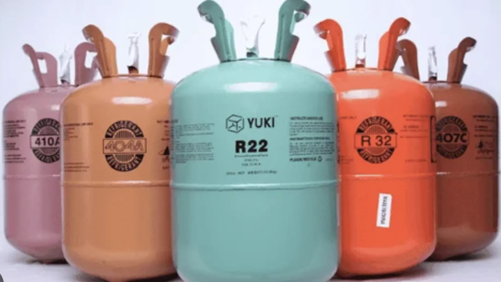 Diverse refrigerant gas cylinders in various colors for commercial and residential HVAC use.