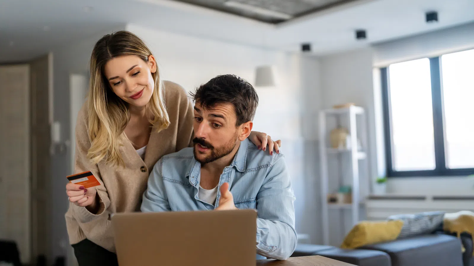a man and a woman looking at a laptop