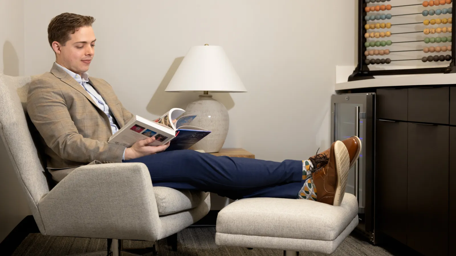 a person sitting in a chair reading a book