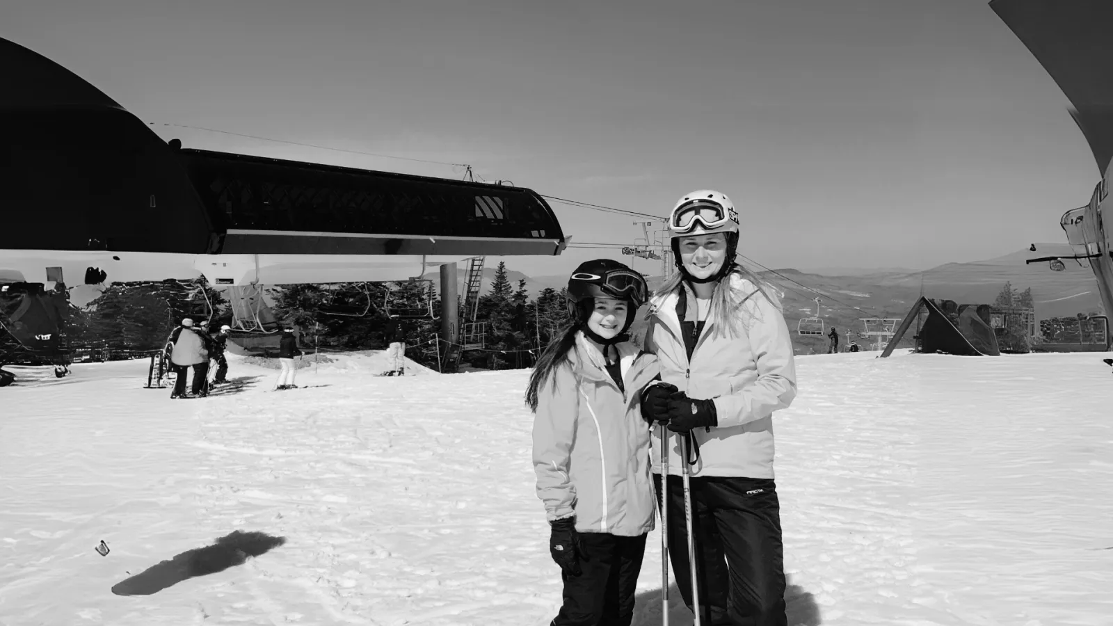 a couple of people pose for a picture on snow skis