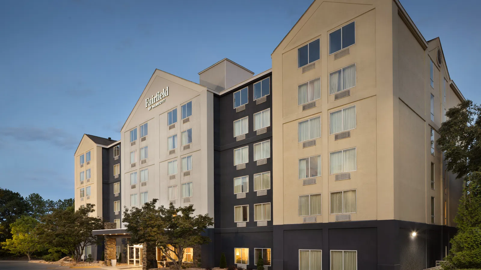 Exterior view of a Fairfield by Marriott hotel building with multiple windows under a clear sky.