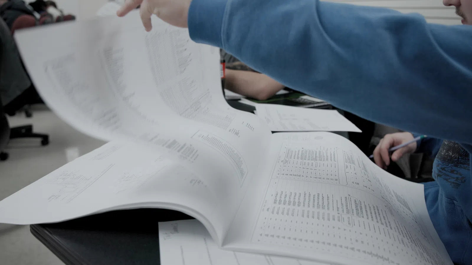 a person writing on a piece of paper