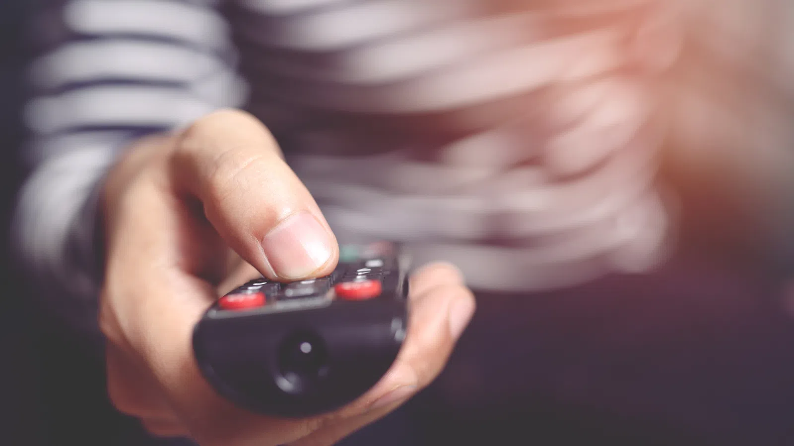 a person holds a remote control