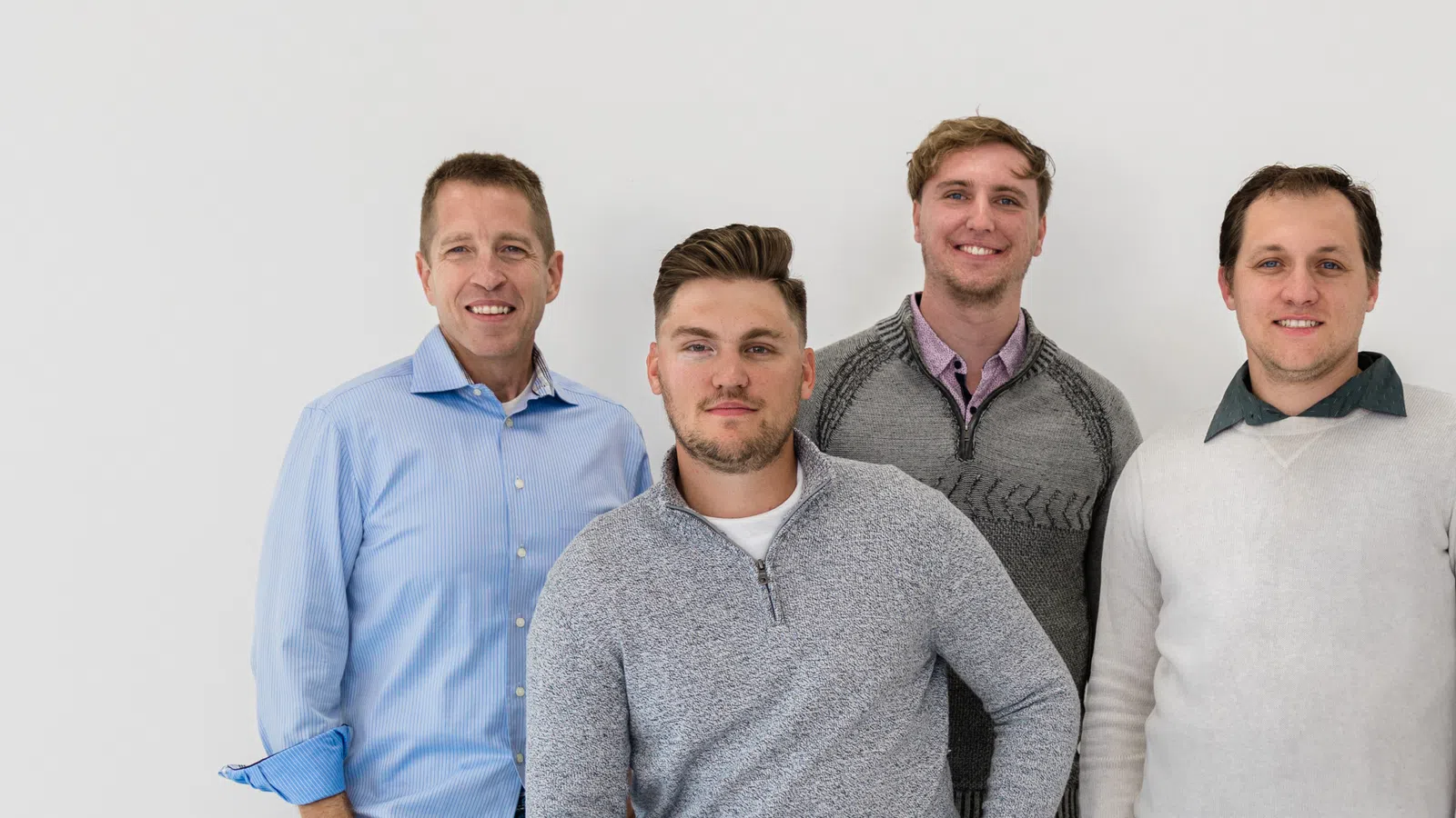 a group of men posing for a photo