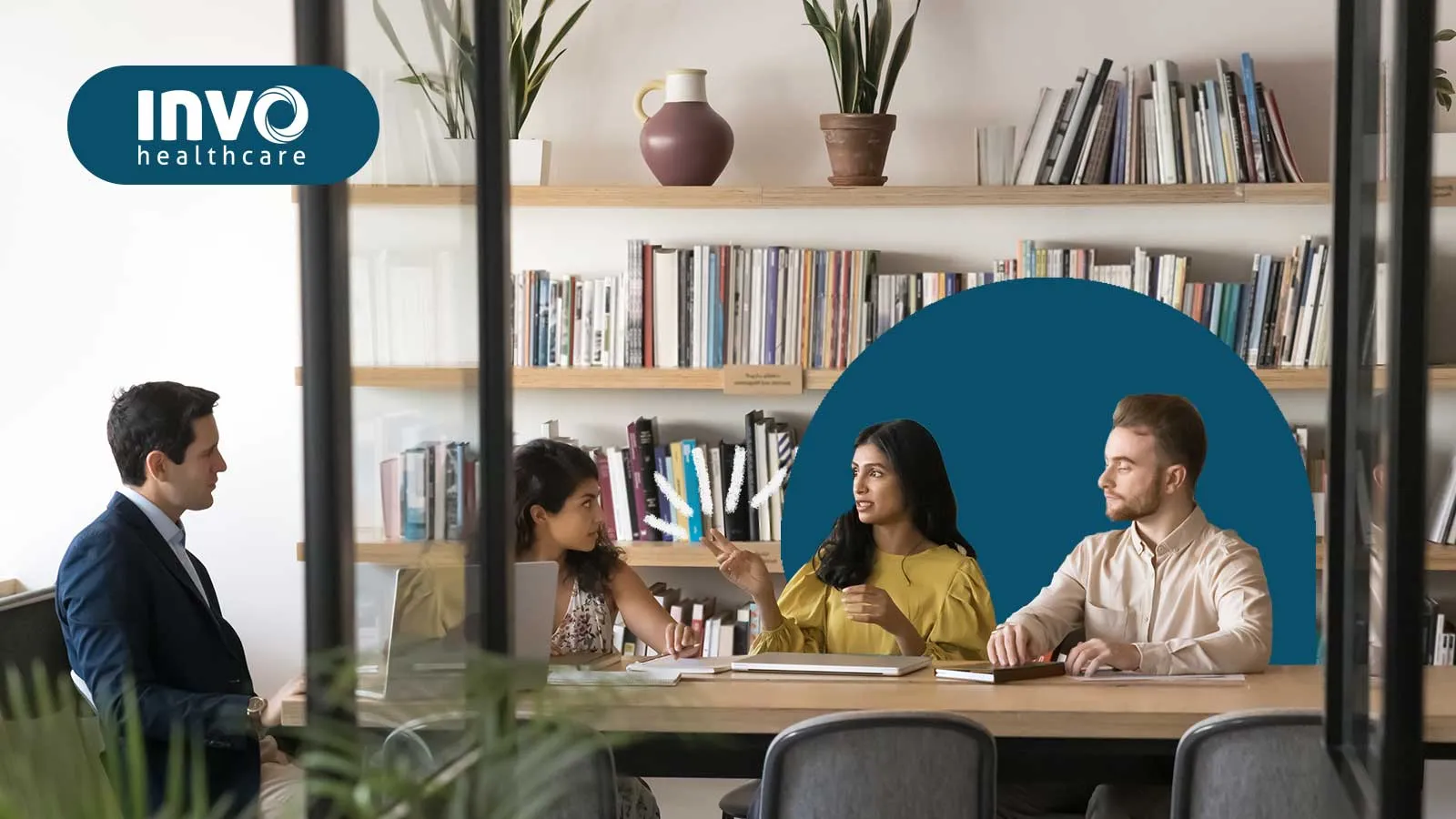 A team meeting in a modern office discussing healthcare solutions.