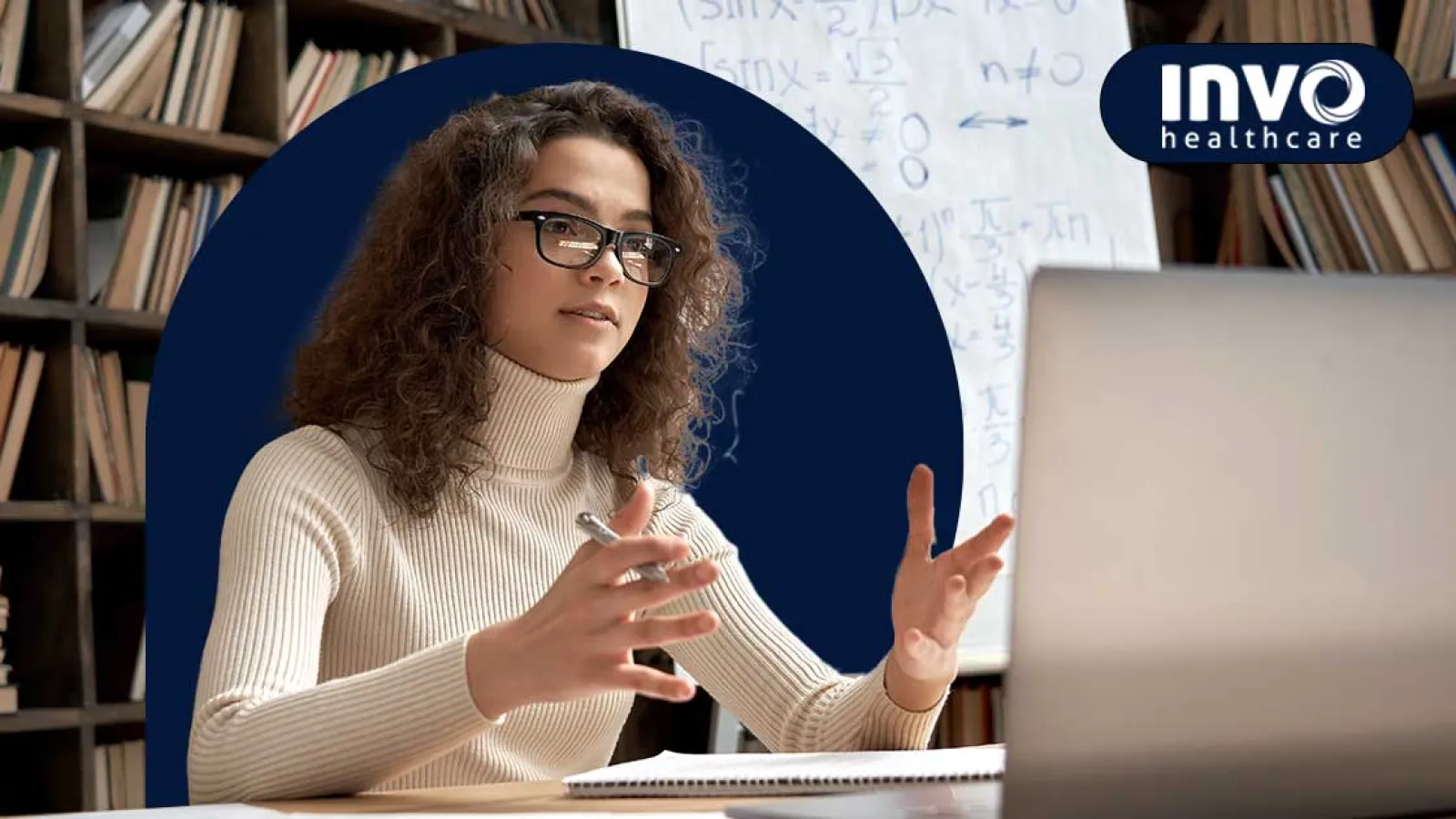 Woman with glasses in a white turtleneck explaining math concepts during an online video call.