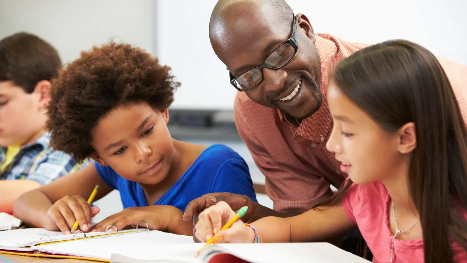 a person and a few children studying