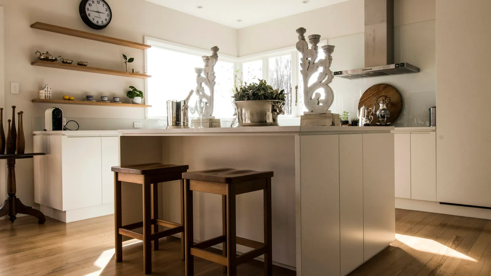 a kitchen with stools and a table