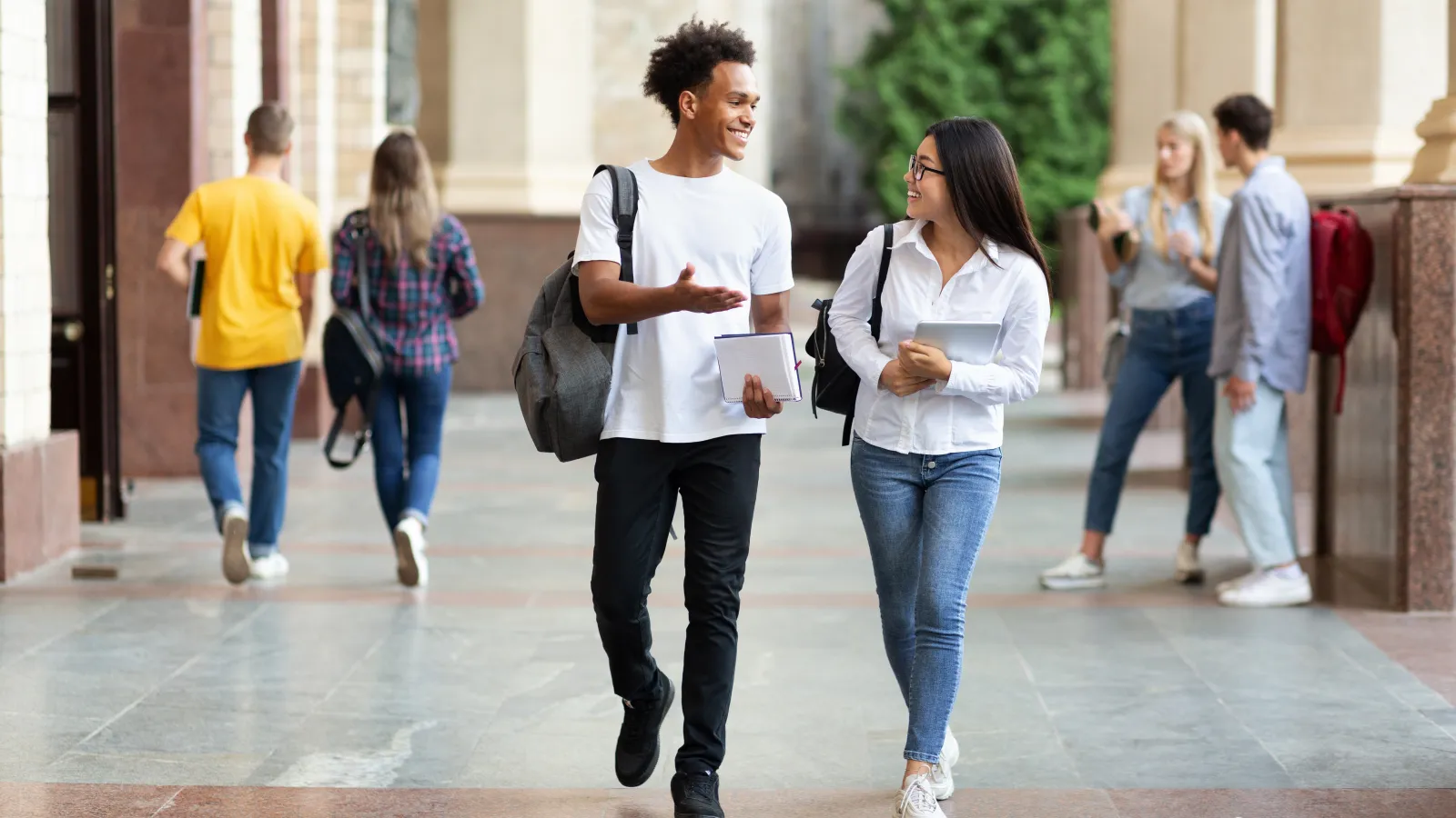 a man and a woman walking on a sidewalk