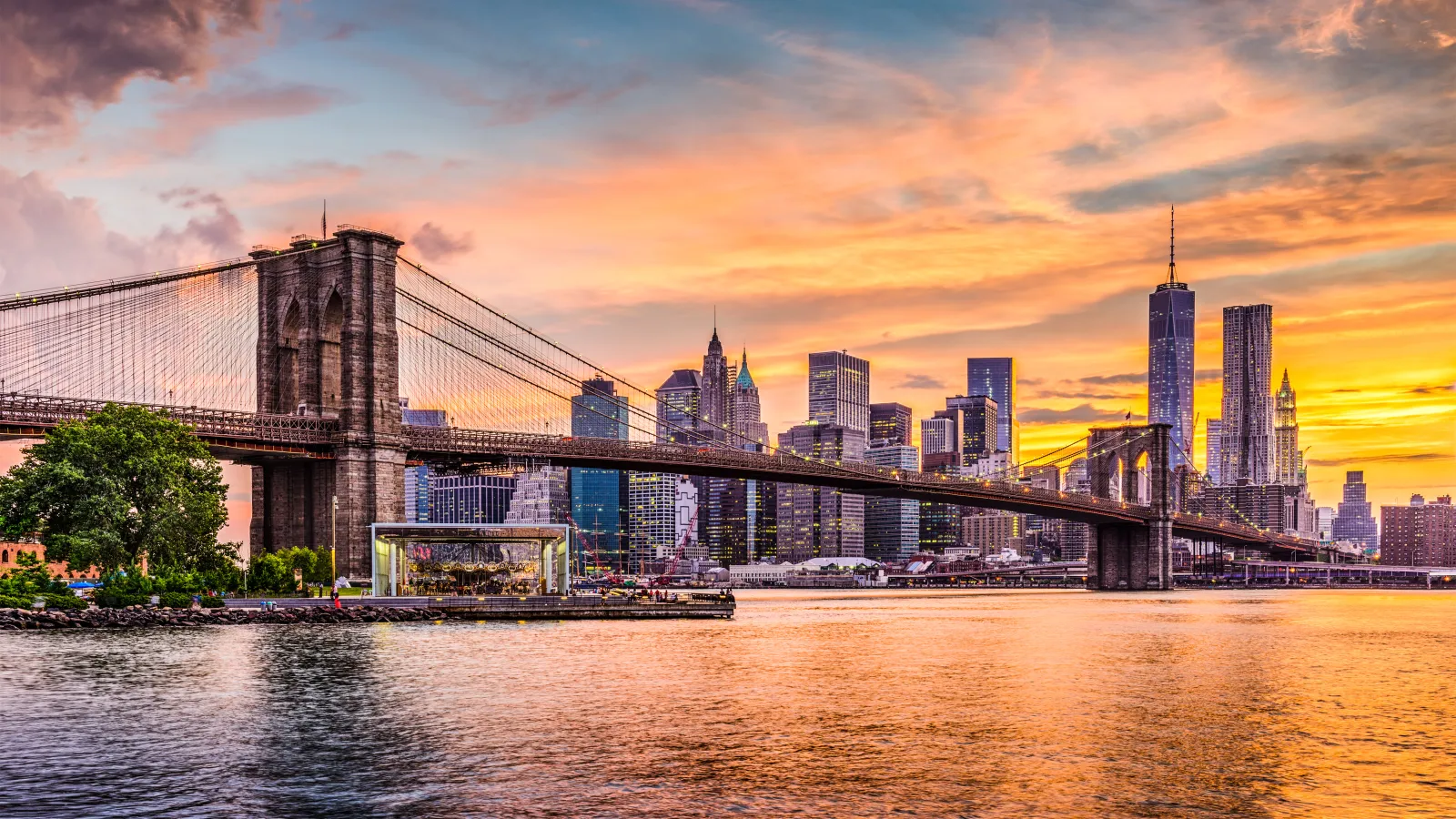 brooklyn bridge over water with NYC in the background