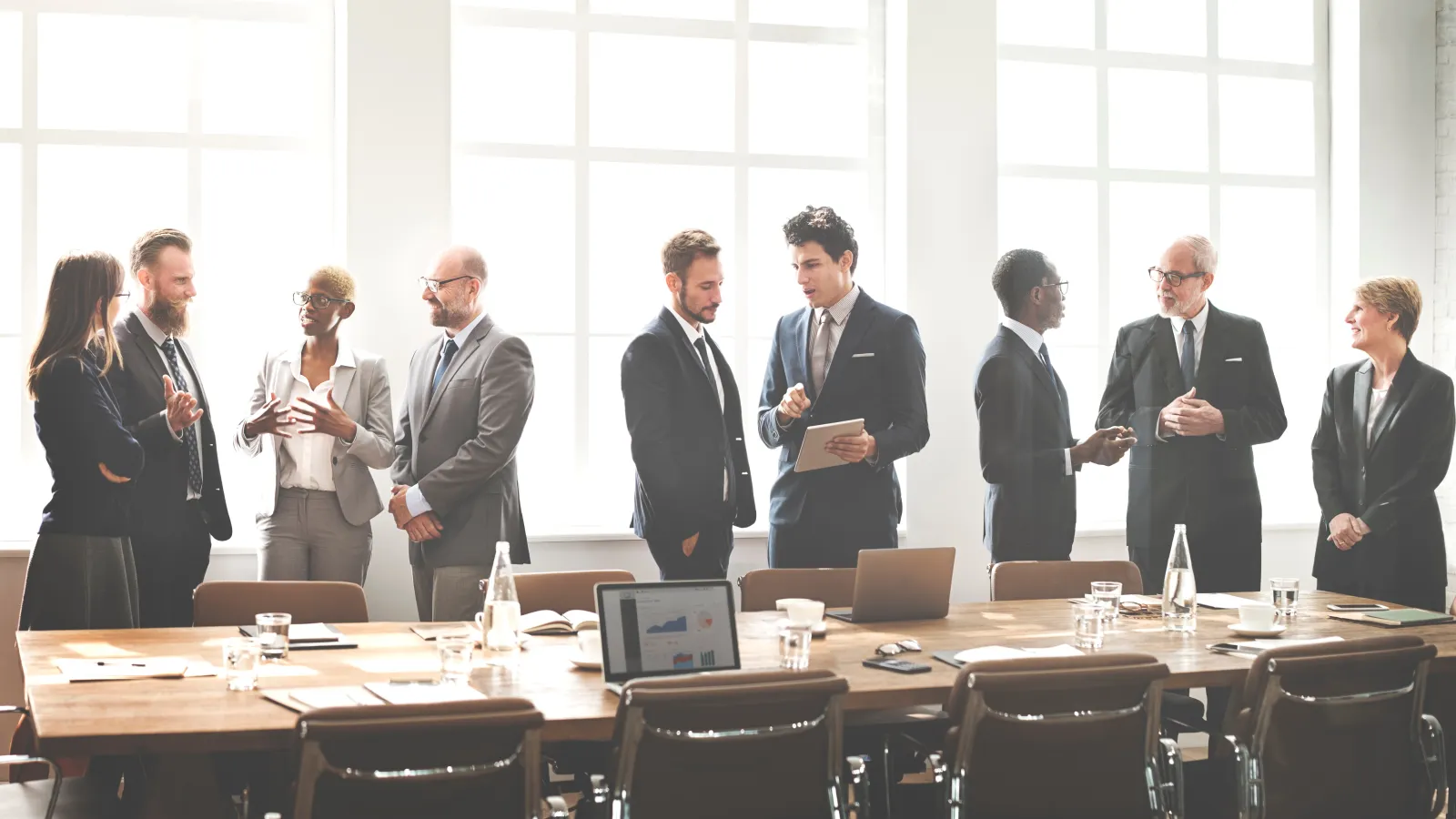 a group of people standing around a table