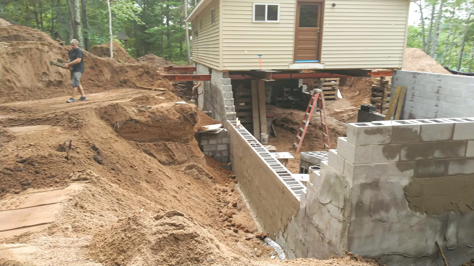 a person standing next to a building under construction
