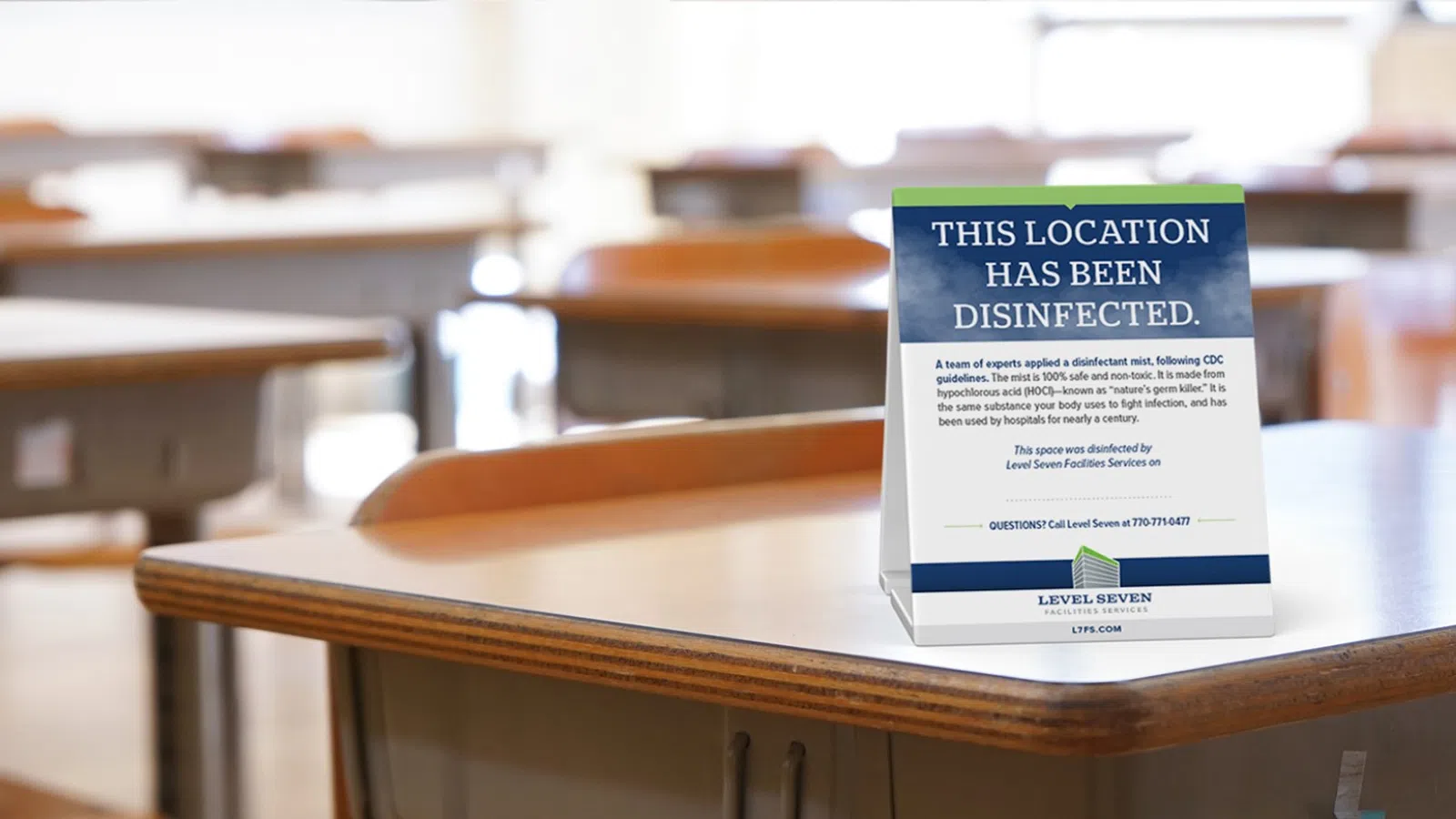 Classroom desks with a disinfected sign indicating cleaning following CDC guidelines for safety.