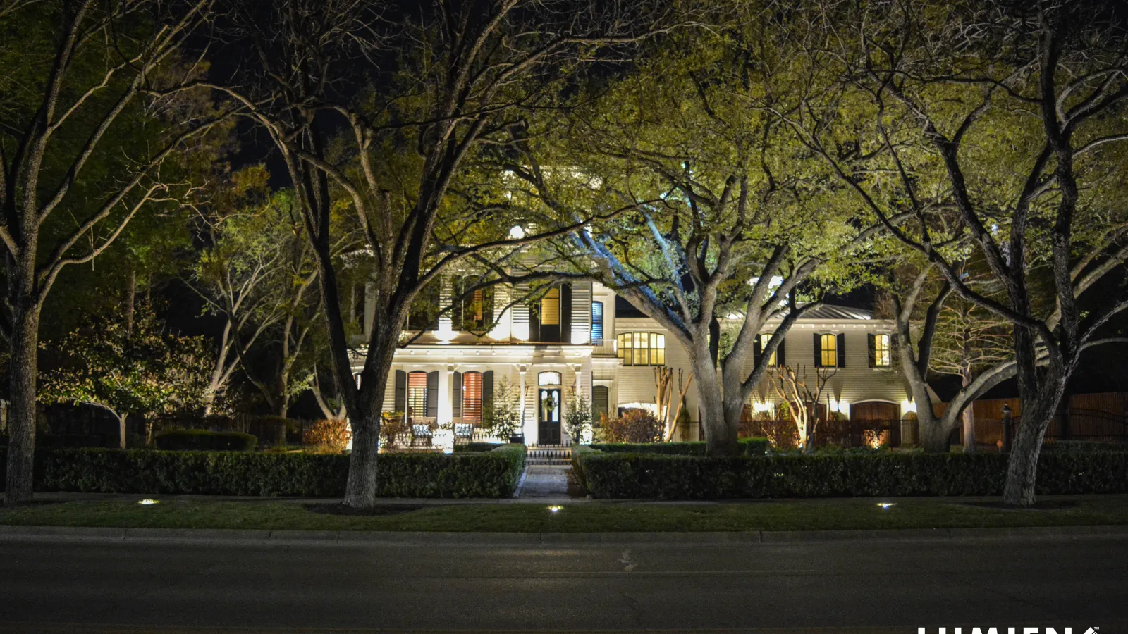 a large house with trees in front of it