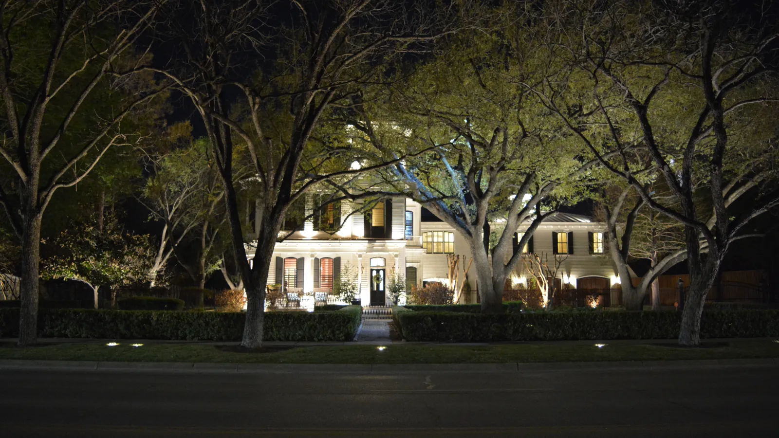 a large house with trees in front of it